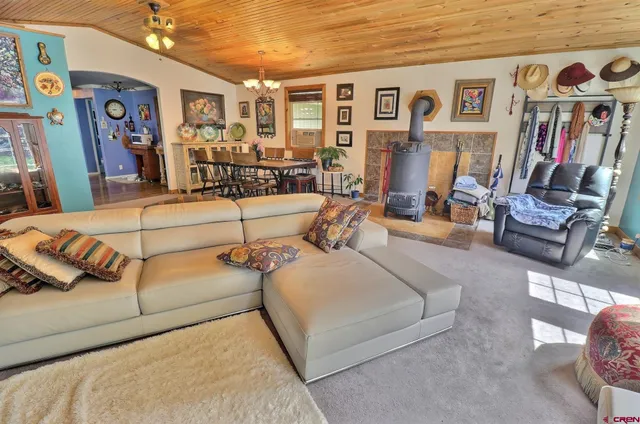 a living room with patio furniture and wooden floor