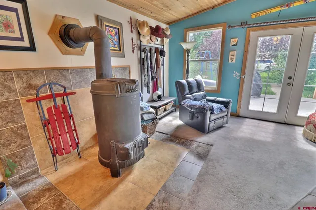 a living room with furniture and a floor to ceiling window