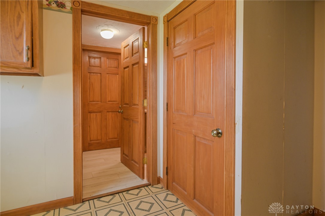 3057 Springfield Xenia Road Springfield, OH 45506 - Photo 22 of 37 This interior hallway features classic wood doors and durable tile flooring.