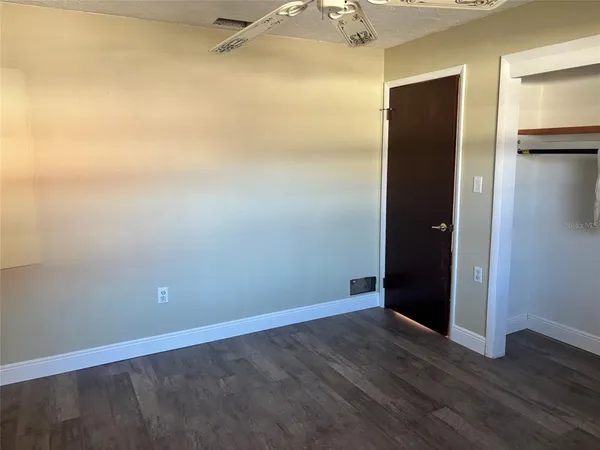 an empty room with wooden floor