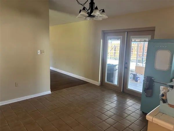 a view of a livingroom with a chandelier fan and window