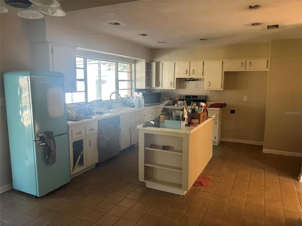 a utility room with cabinets washer and dryer