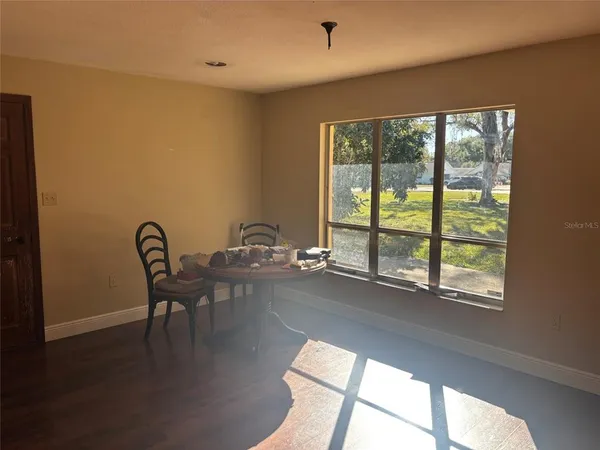 a view of a workspace with furniture and window