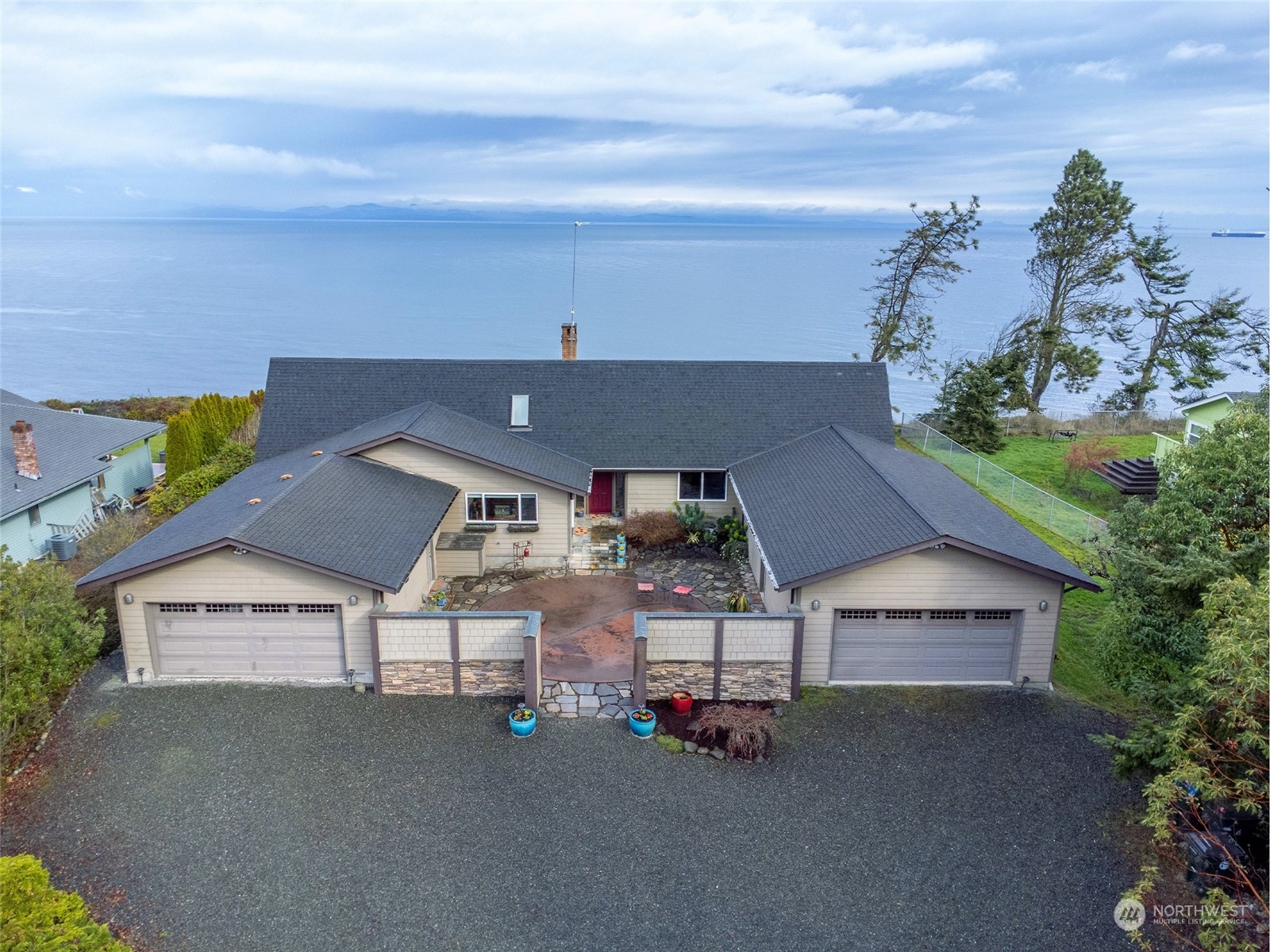 an aerial view of a house with roof deck fireplace and furniture