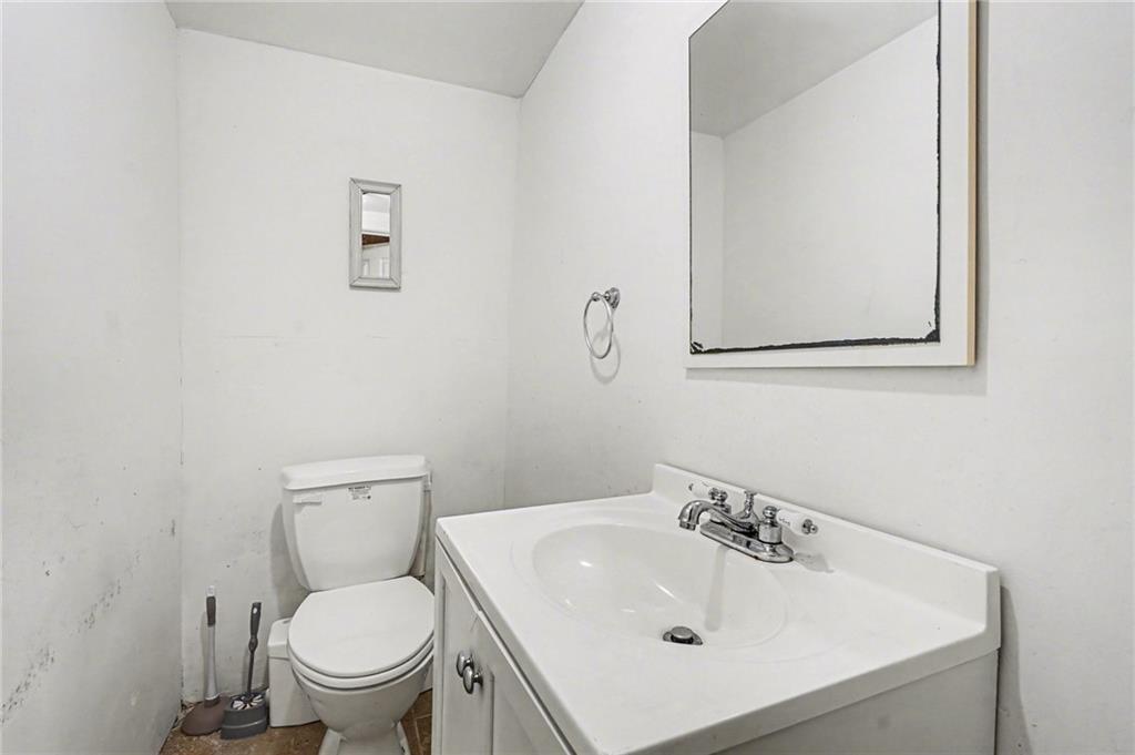 2530 Rockbridge Road Northwest Conyers, GA 30012 - Photo 36 of 45 a white toilet sitting next to a bathroom sink