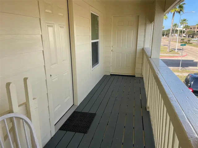 a view of a hallway and wooden floor