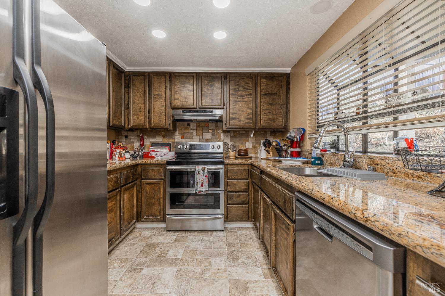 2454 Sebastopol Lane Hayward, CA 94542 - Photo 15 of 35 a kitchen with stainless steel appliances granite countertop a sink stove and refrigerator