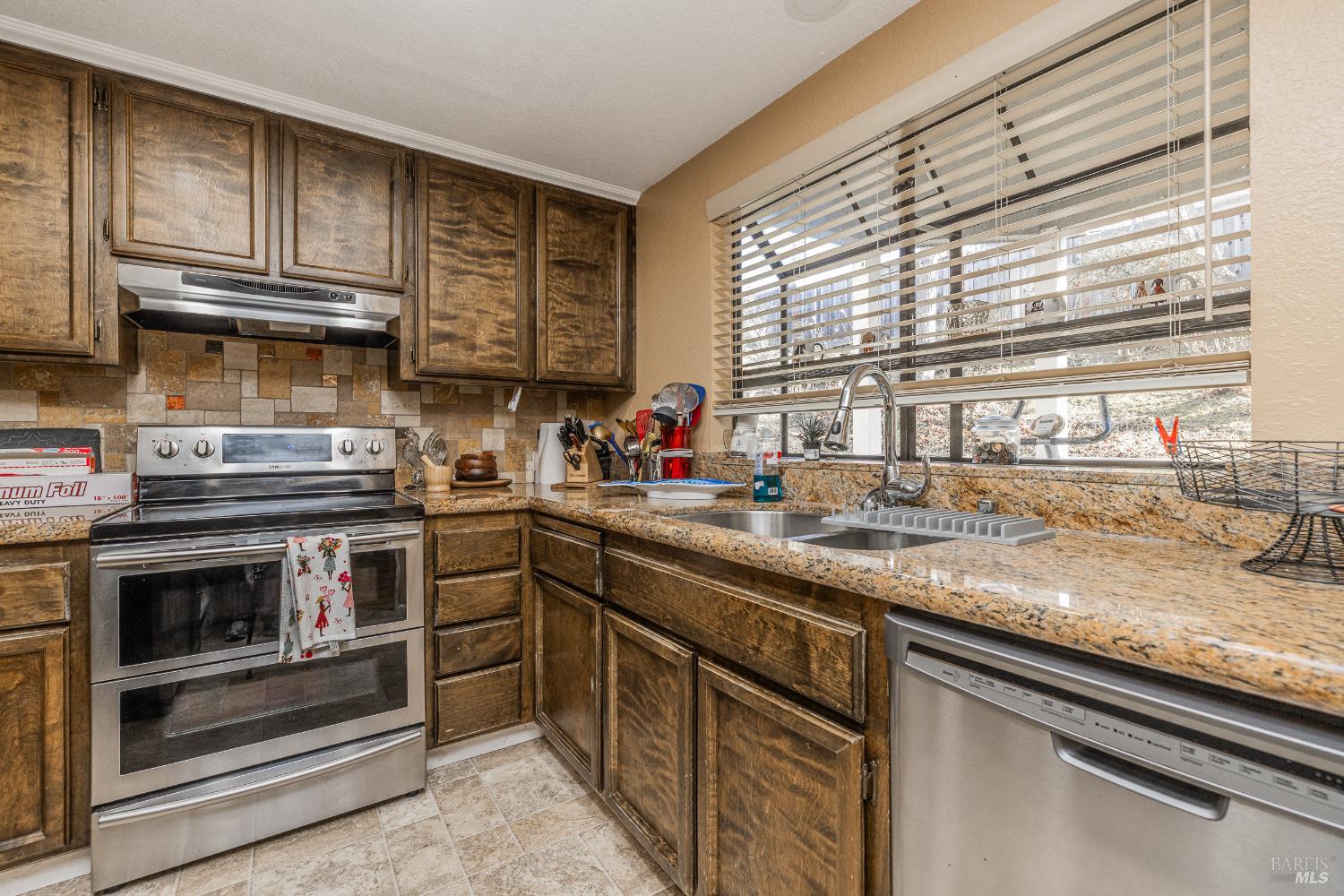 2454 Sebastopol Lane Hayward, CA 94542 - Photo 16 of 35 a kitchen with stainless steel appliances granite countertop a sink a stove and cabinets
