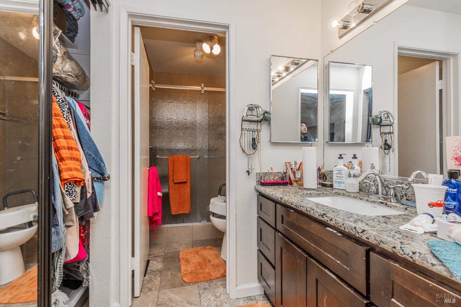 2454 Sebastopol Lane Hayward, CA 94542 - Photo 23 of 35 a bathroom with a granite countertop sink a mirror and a shower