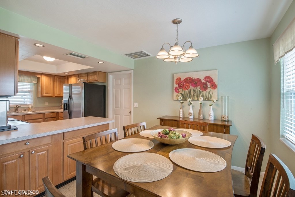 1672 South Mayfair Road Fort Myers, FL 33919 - Photo 7 of 14 a view of a dining room with furniture wooden floor and chandelier