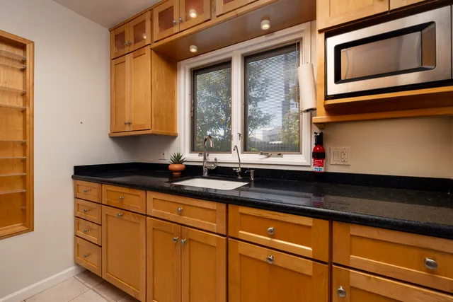 a kitchen with stainless steel appliances granite countertop a stove and a microwave