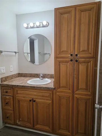 a bathroom with a sink a vanity and a mirror