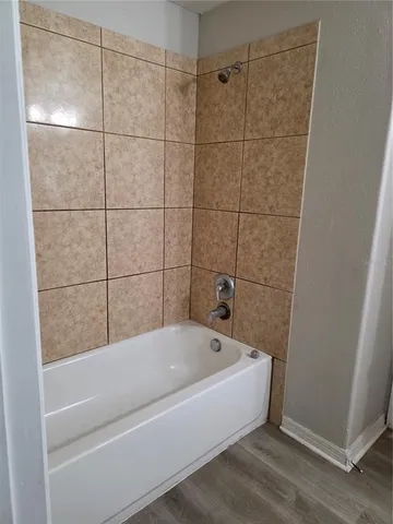 a bathroom with a bathtub and shower