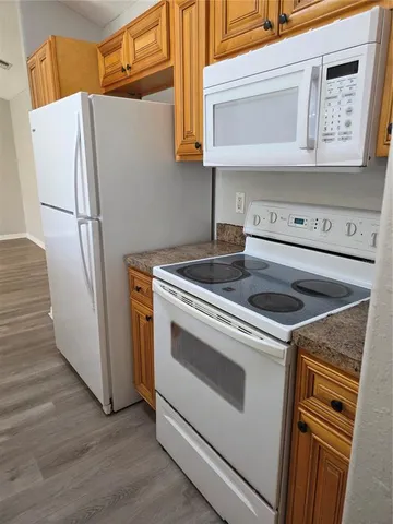 a white stove top oven sitting inside of a kitchen