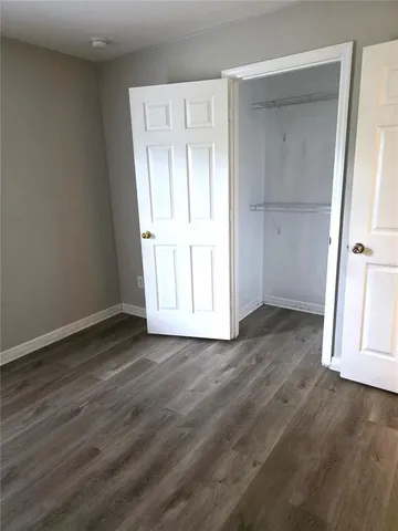 an empty room with wooden floor and door