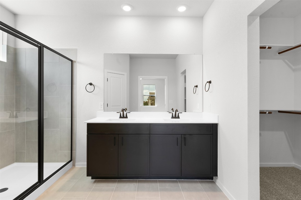 101 Coyote Willow Way Georgetown, TX 78633 - Photo 11 of 34 a bathroom with a double vanity sink and mirror