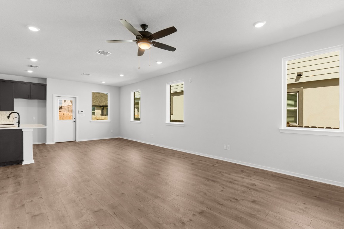101 Coyote Willow Way Georgetown, TX 78633 - Photo 12 of 34 wooden floor in an empty room with a window