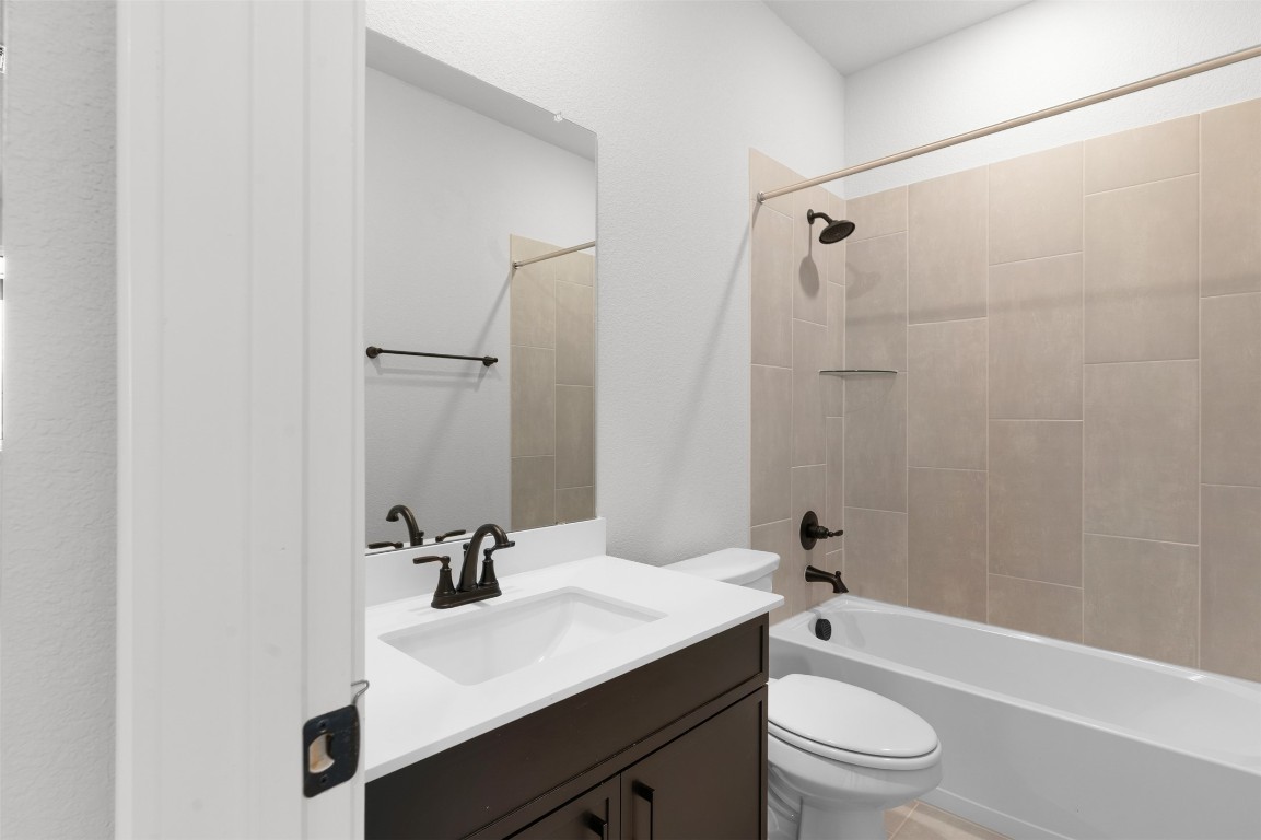 101 Coyote Willow Way Georgetown, TX 78633 - Photo 16 of 34 a bathroom with a sink a toilet and shower