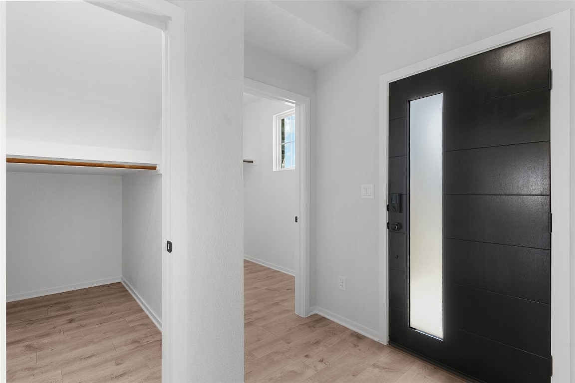 101 Coyote Willow Way Georgetown, TX 78633 - Photo 6 of 34 a view of a hallway with wooden floor and closet