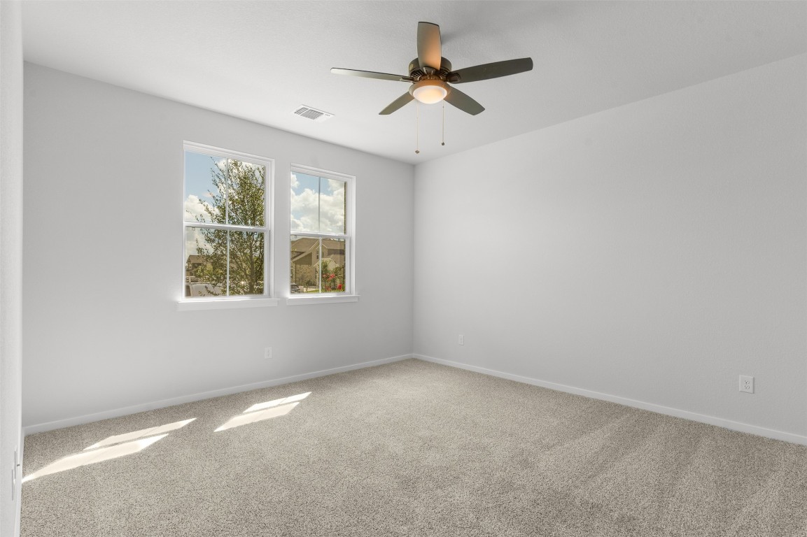 101 Coyote Willow Way Georgetown, TX 78633 - Photo 10 of 34 an empty room with a window and a fan