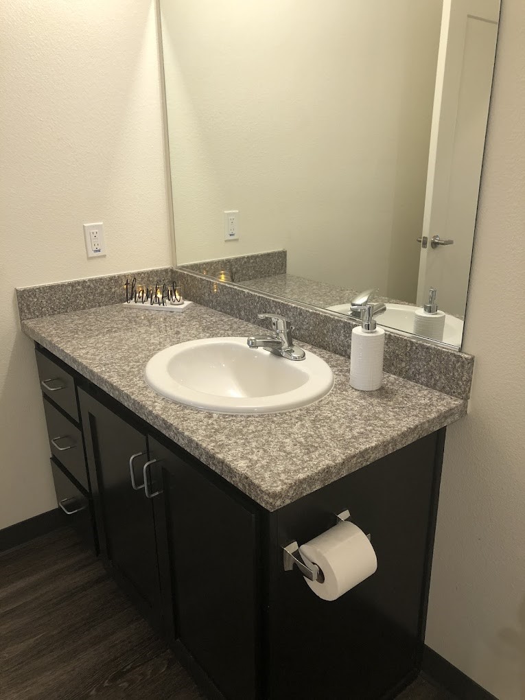 200 East 10th Street Gilroy, CA 95020 - Photo 12 of 14 a bathroom with a granite countertop sink and a mirror