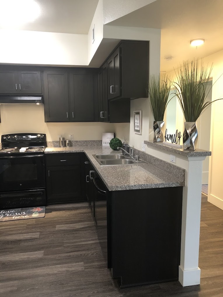 200 East 10th Street Gilroy, CA 95020 - Photo 10 of 14 a kitchen with a sink cabinets and a wooden floor