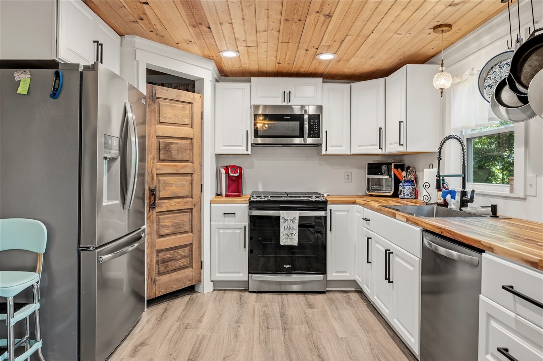 30 Mobleys Bluff Road Abbeville, SC 29620 - Photo 12 of 35 Rich wood plank ceilings and warm butcher block countertops elevate this classic kitchen design.