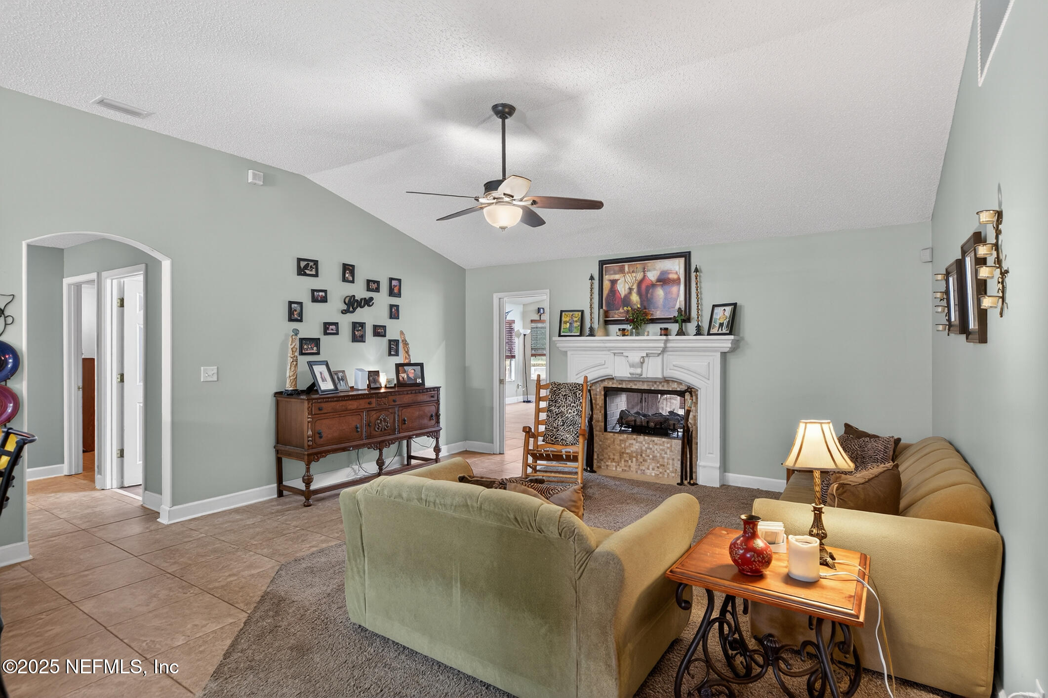 701 Camp Francis Johnson Road Orange Park, FL 32065 - Photo 22 of 64 a living room with furniture and a fireplace