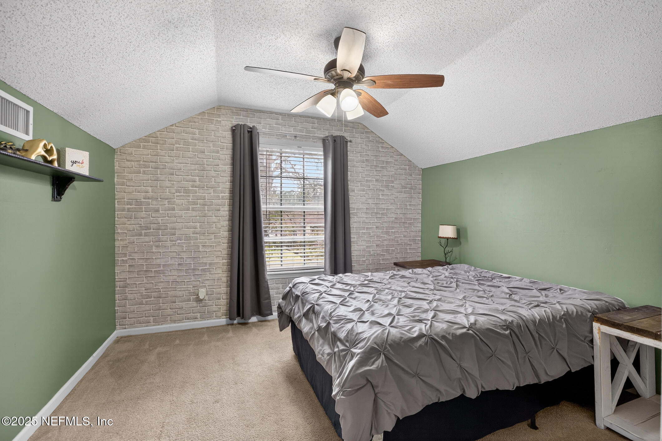 701 Camp Francis Johnson Road Orange Park, FL 32065 - Photo 43 of 64 a bedroom with a bed and a chandelier