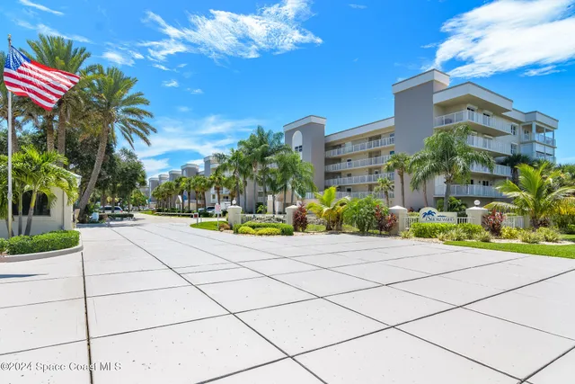 a kitchen with stainless steel appliances granite countertop a sink stove refrigerator and cabinets