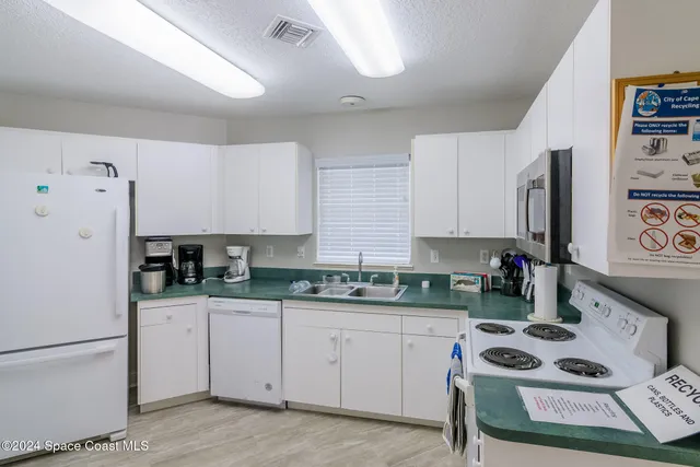 a living room with lots of furniture and a wooden floor