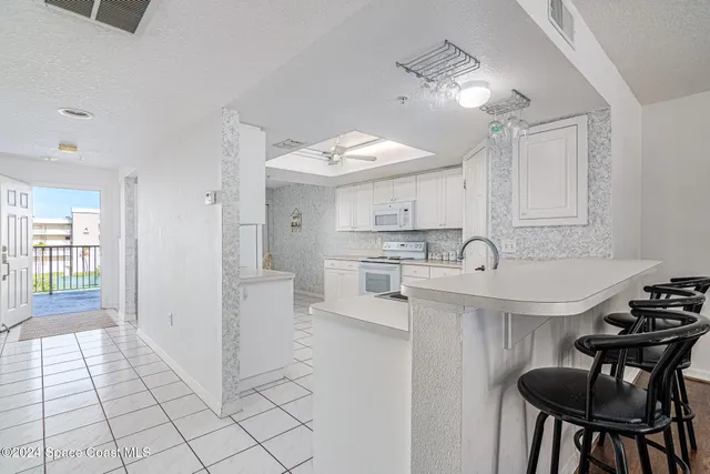 a kitchen with granite countertop cabinets and refrigerator