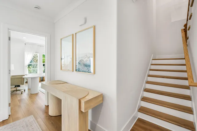 a view of entryway and hall with wooden floor