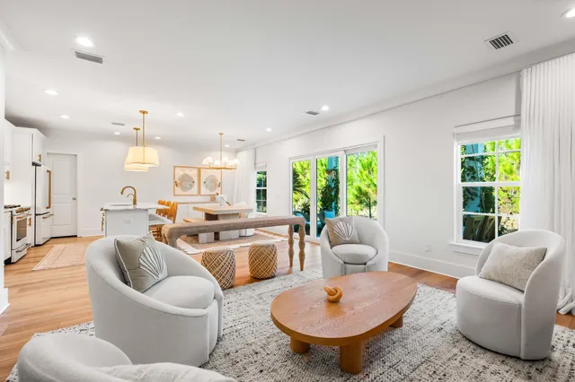 a living room with furniture a large window and a table