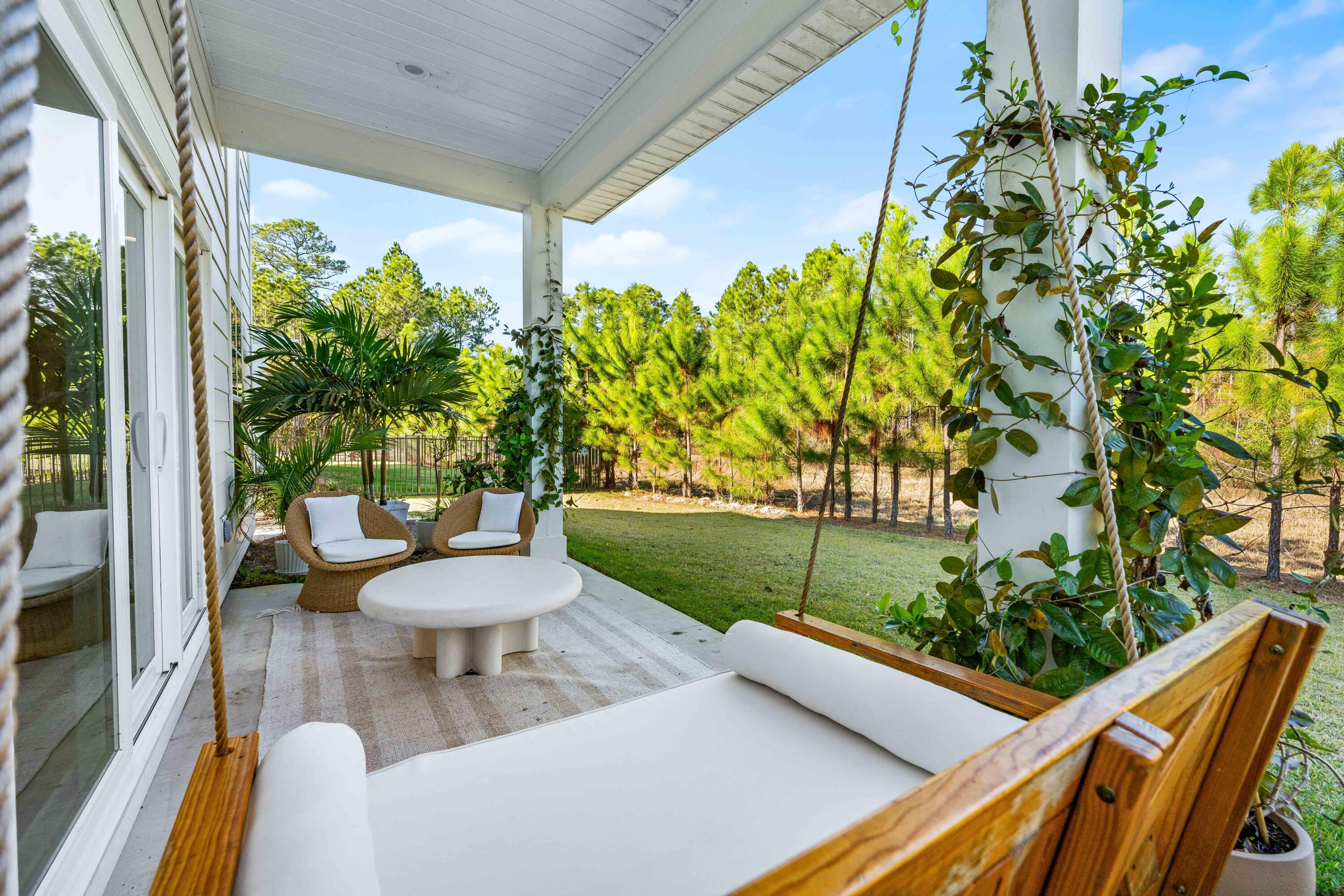 15 Sugar Sands Drive Santa Rosa Beach, FL 32459 - Photo 32 of 46 a view of a chair and table in the patio with a garden