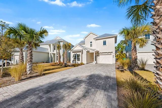 a view of house with outdoor space and palm trees