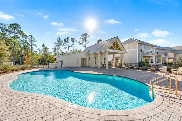a view of a house with swimming pool and sitting area