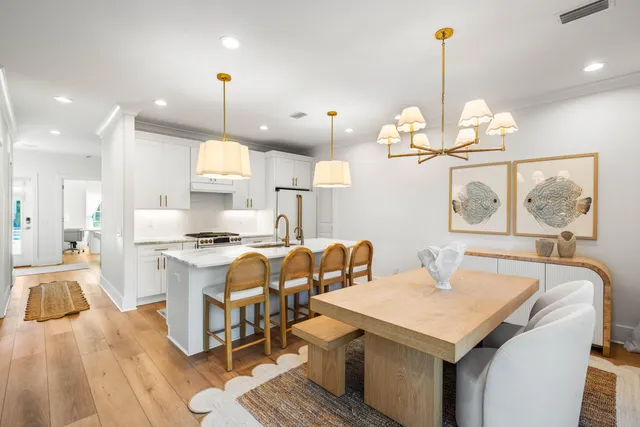 a large kitchen with a table and chairs