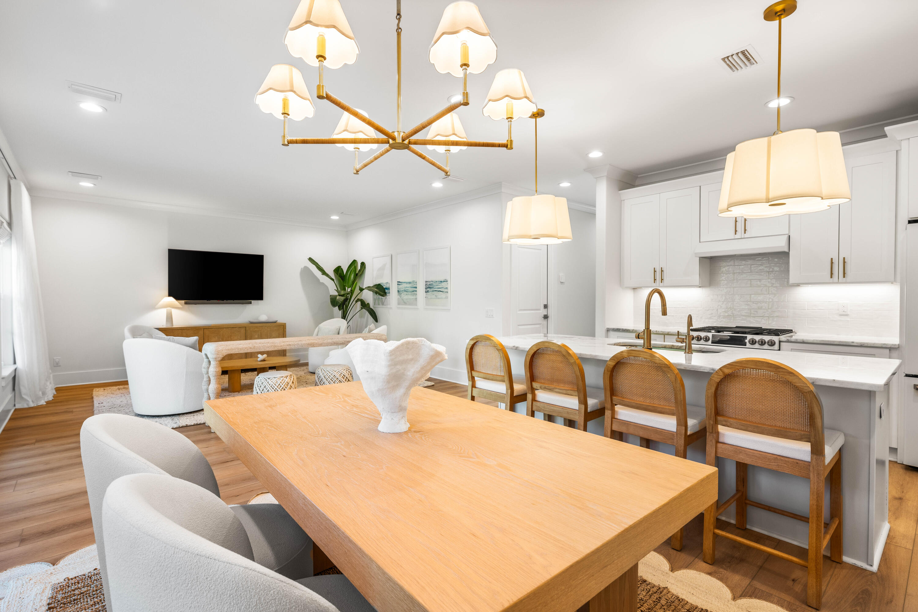 15 Sugar Sands Drive Santa Rosa Beach, FL 32459 - Photo 8 of 46 a kitchen with stainless steel appliances kitchen island granite countertop a sink a stove a dining table and chairs