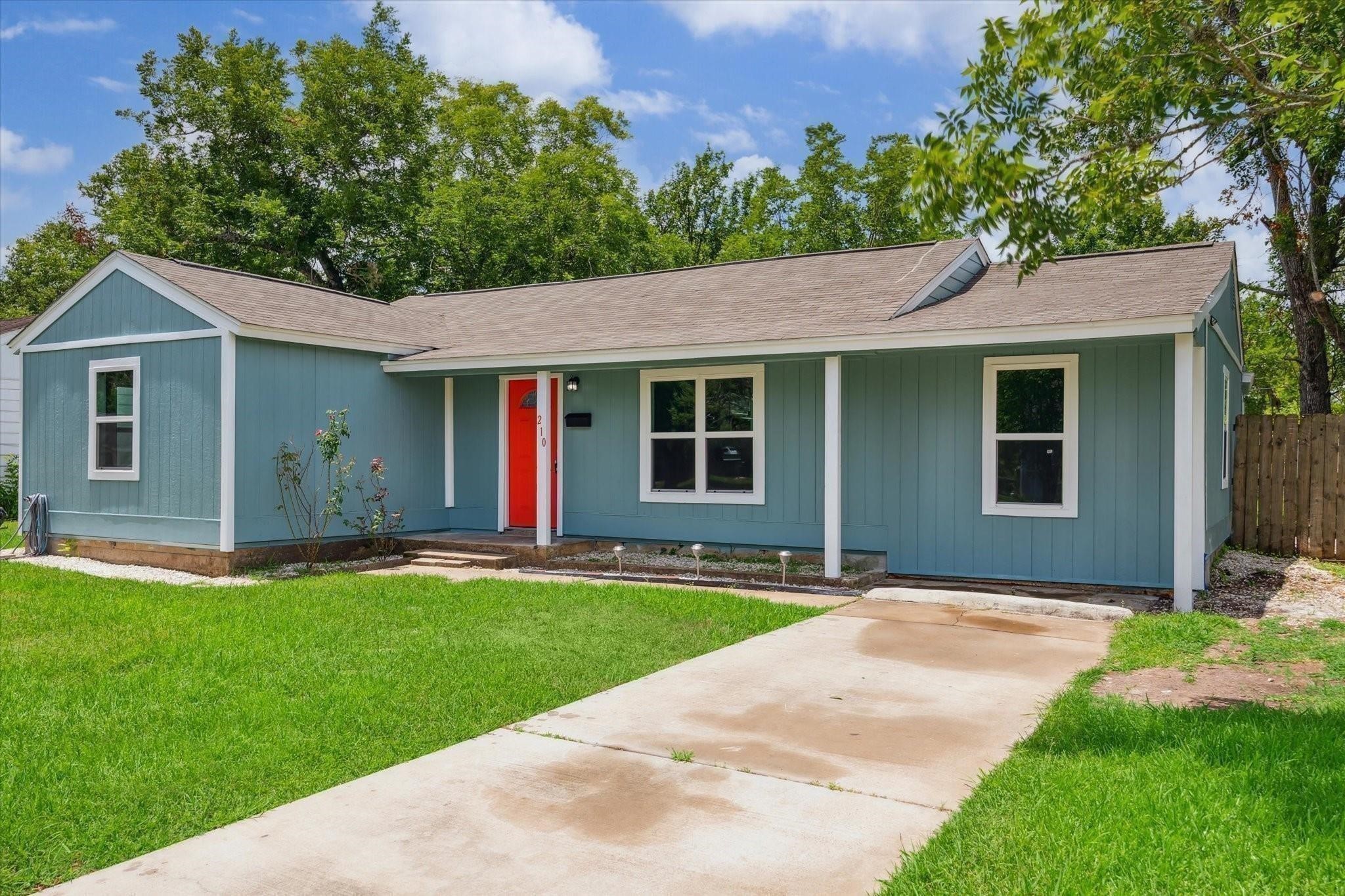 210 Laurel Street Lake Jackson, TX 77566 - Photo 1 of 13 a front view of house with yard and green space