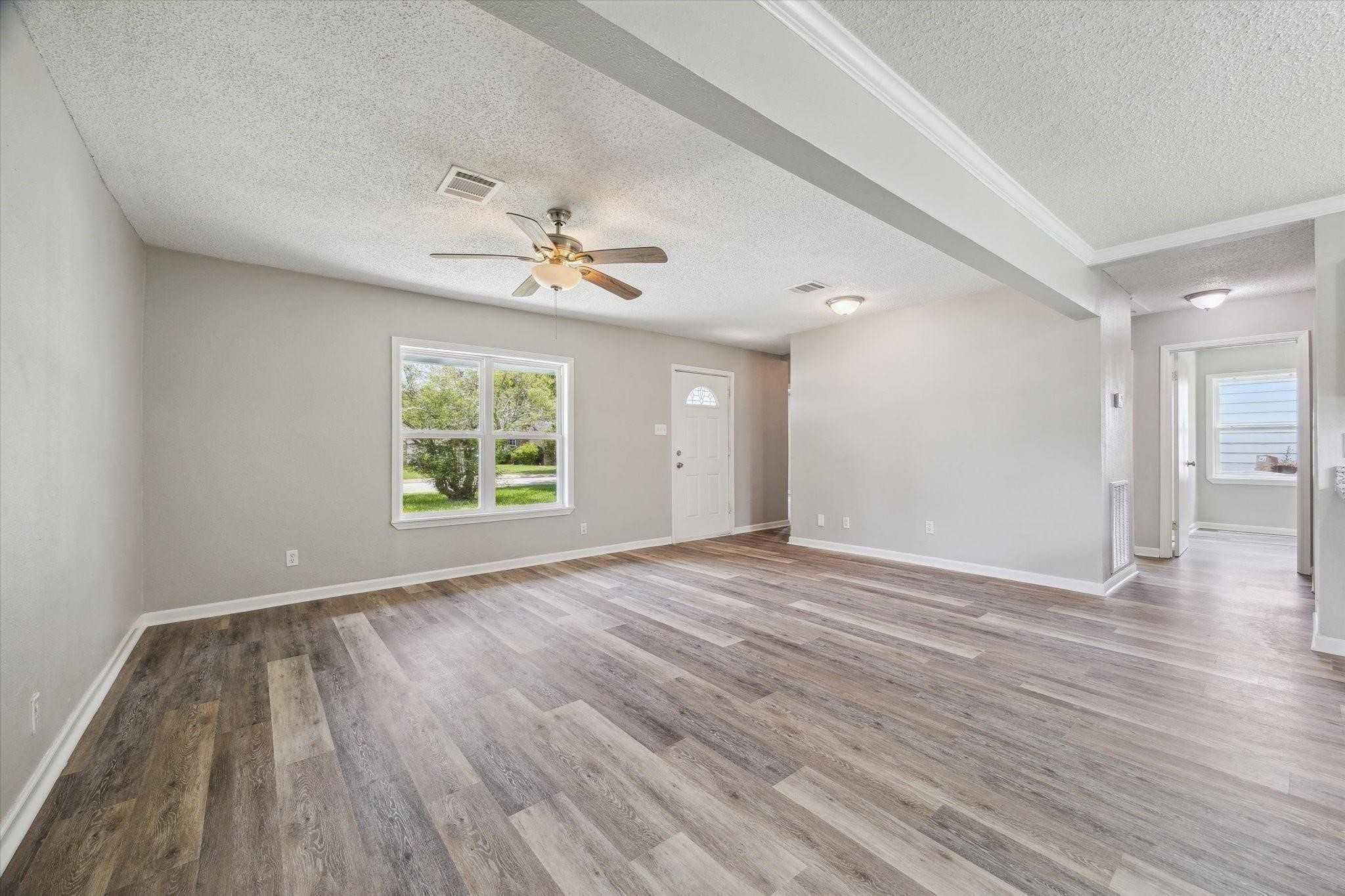 210 Laurel Street Lake Jackson, TX 77566 - Photo 3 of 13 wooden floor in an empty room with a window