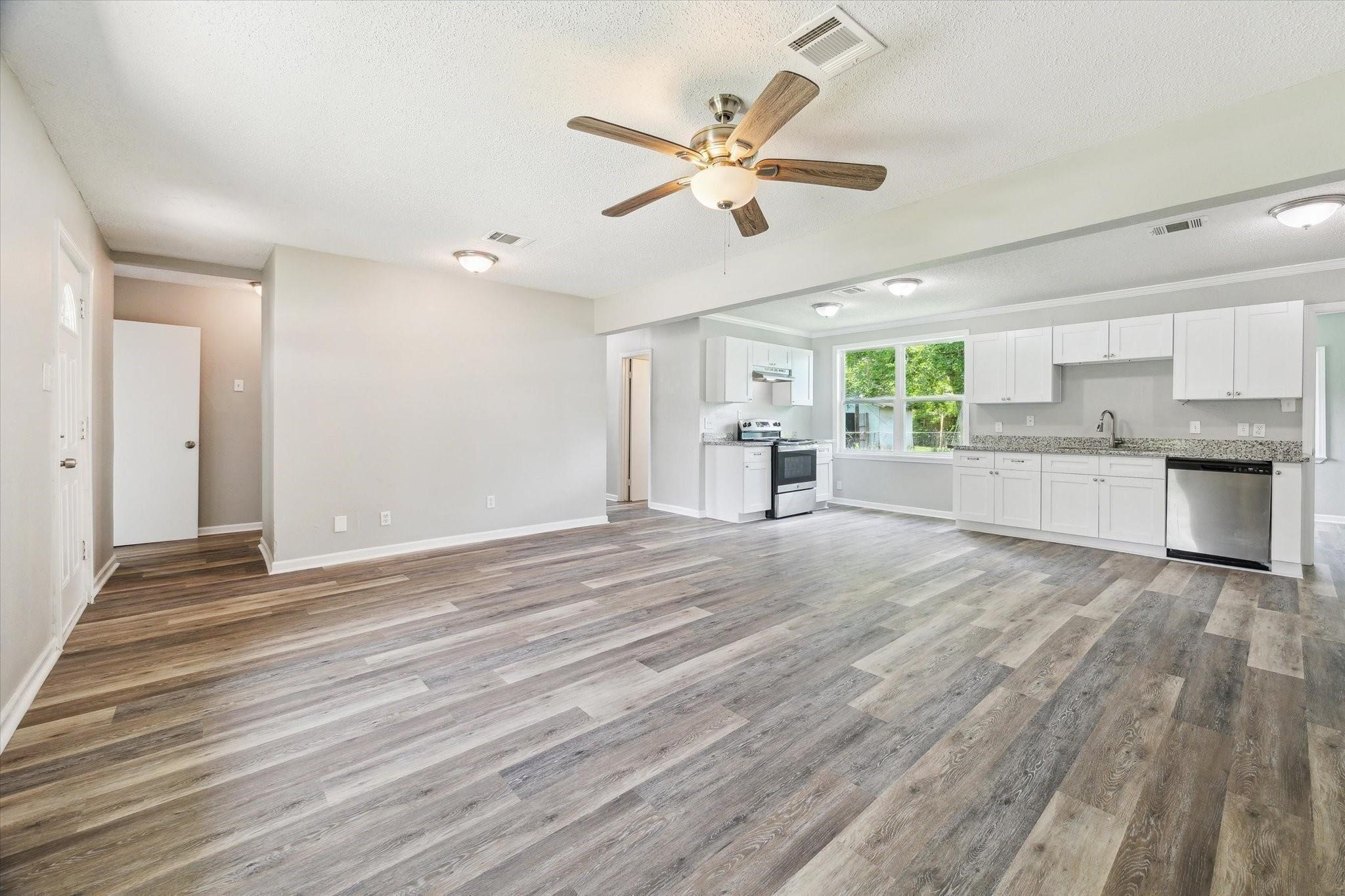 210 Laurel Street Lake Jackson, TX 77566 - Photo 4 of 13 a view of an empty room and kitchen view