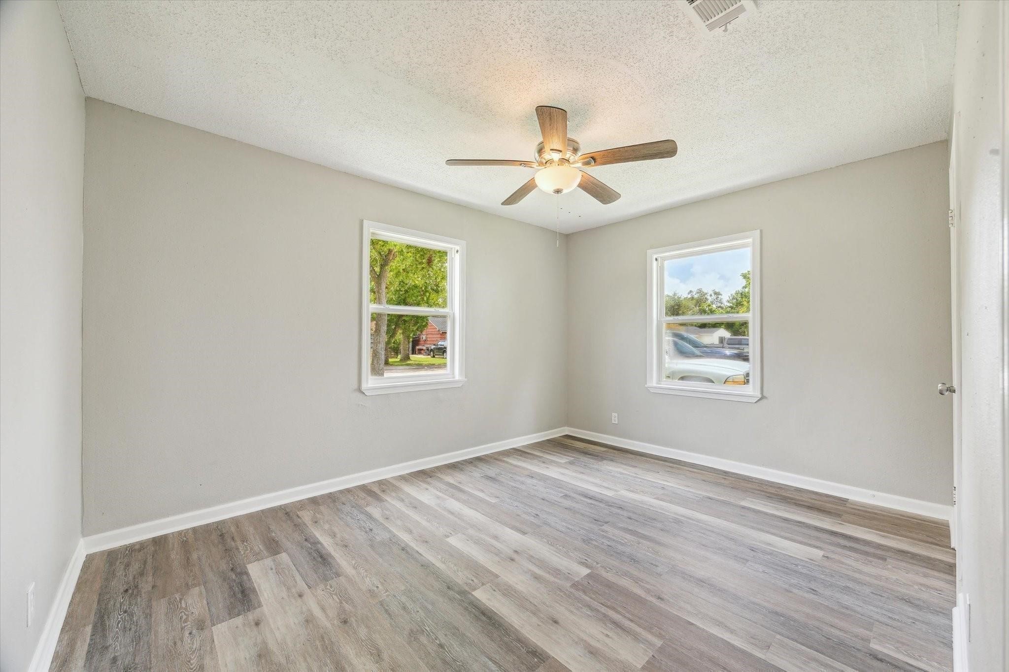 210 Laurel Street Lake Jackson, TX 77566 - Photo 6 of 13 a view of empty room with wooden floor and fan