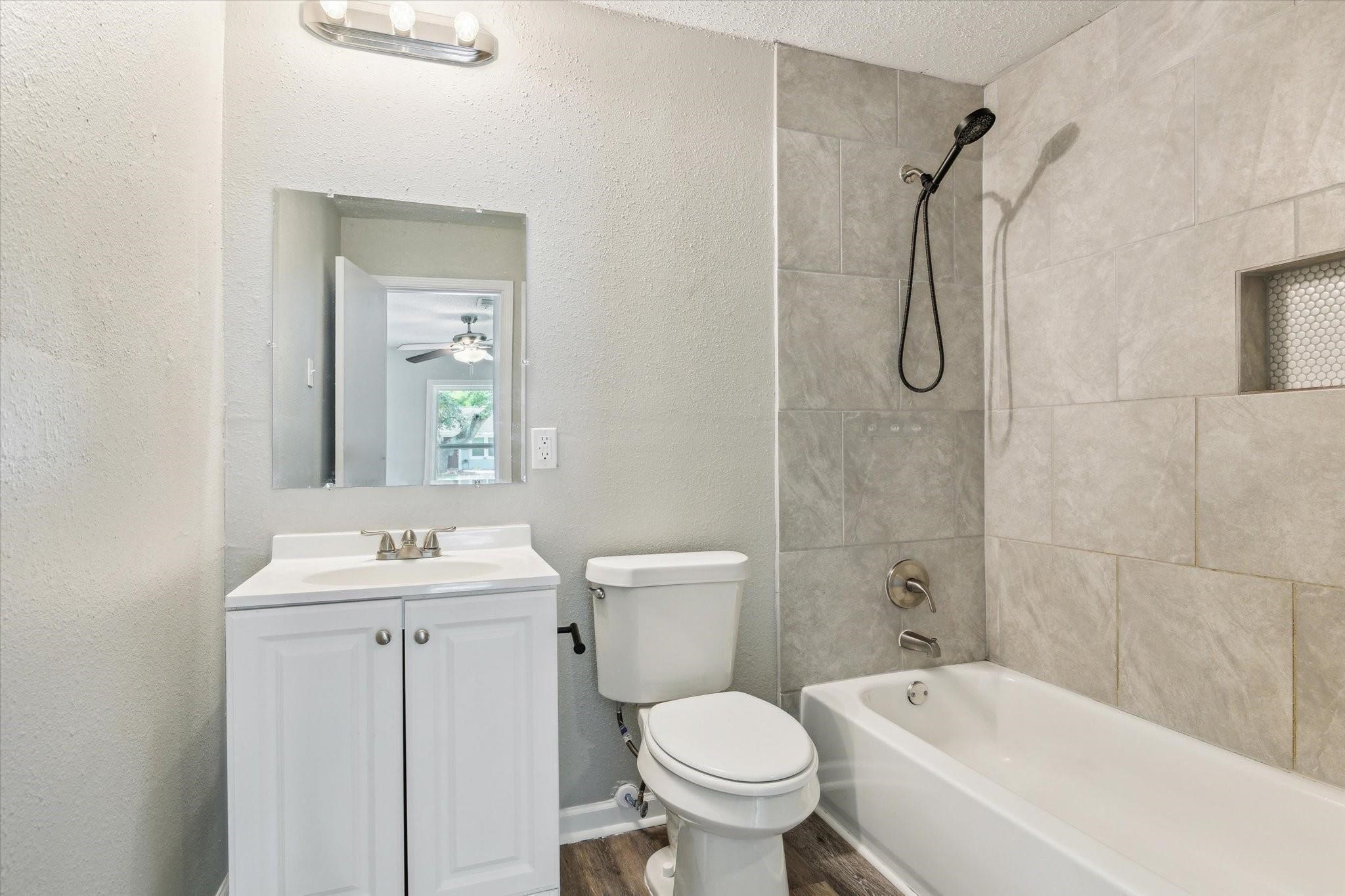 210 Laurel Street Lake Jackson, TX 77566 - Photo 10 of 13 a bathroom with a sink toilet and shower