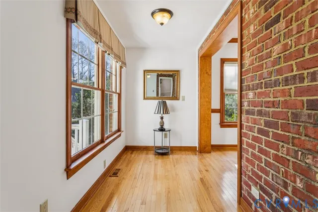 a view of an entryway with wooden floor