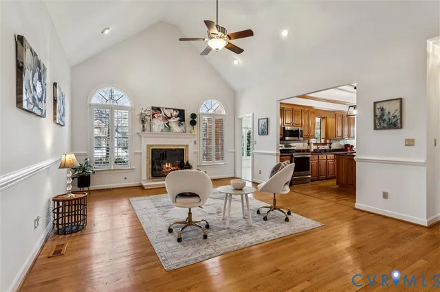 a living room with furniture a fireplace and a chandelier