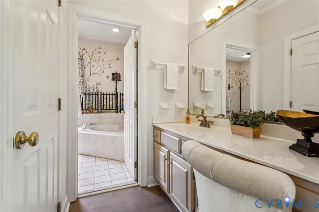 a bathroom with a tub sink and mirror
