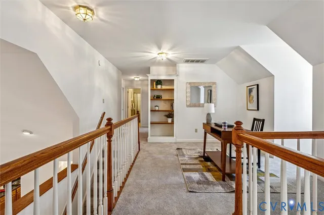 a view of a hallway with seating space