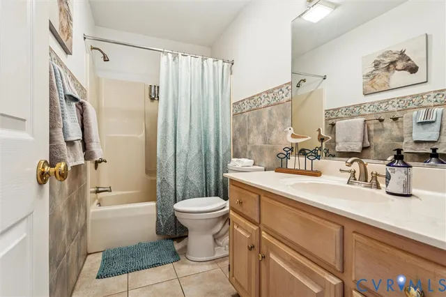 a bathroom with a sink a toilet a mirror and shower