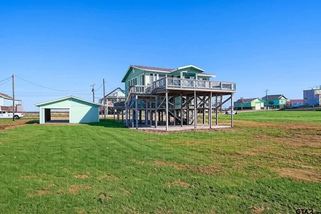 a view of a house with a yard and sitting area